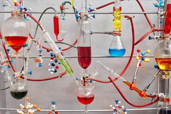glass-test-tubes-with-colorful-viscous-liquid-isolated-gray-surface-chemical-laboratory_176532-14364